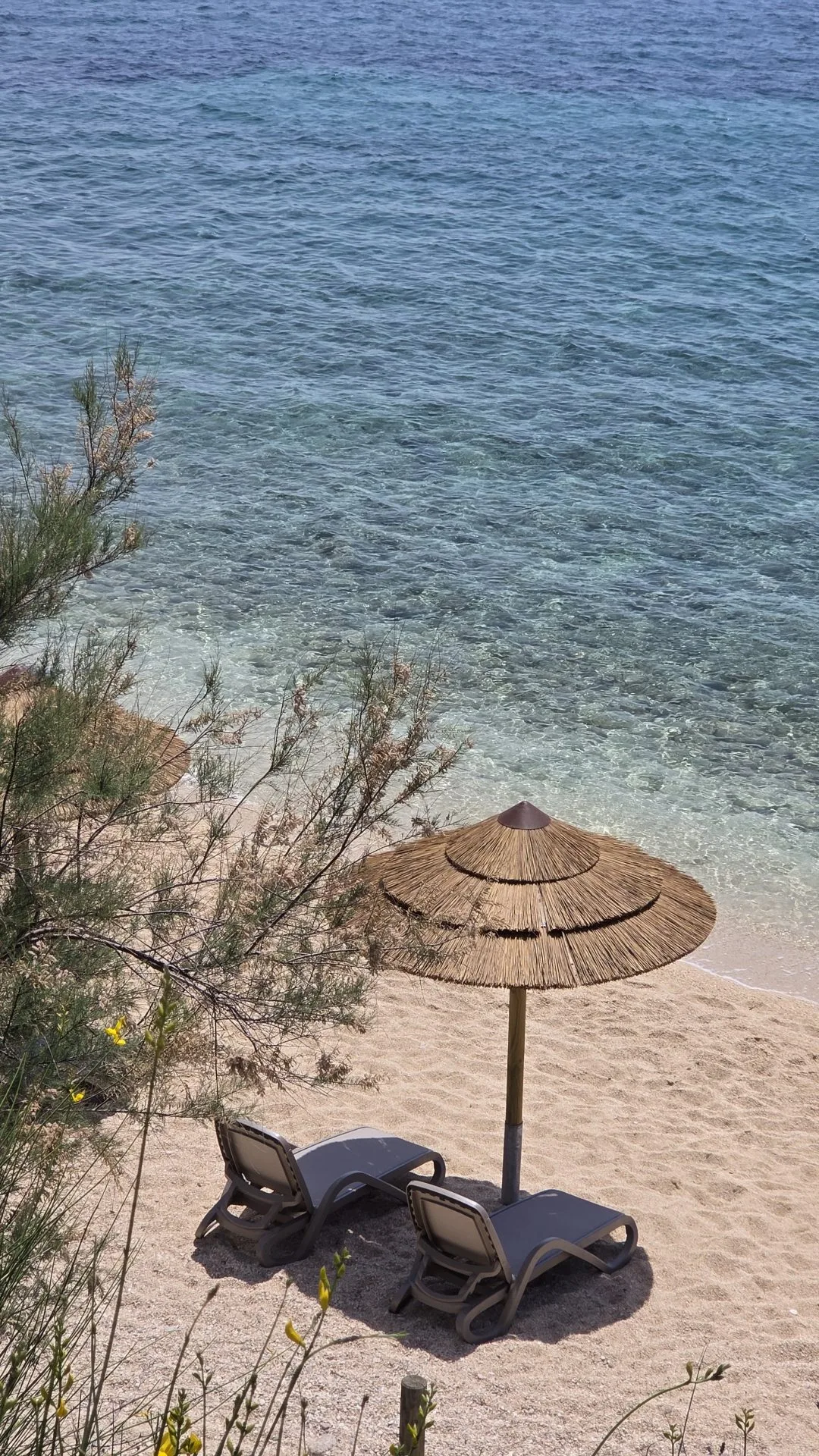 Skrila beach at the Stara Baška camp — crystal water, sun beds, cocktail bar