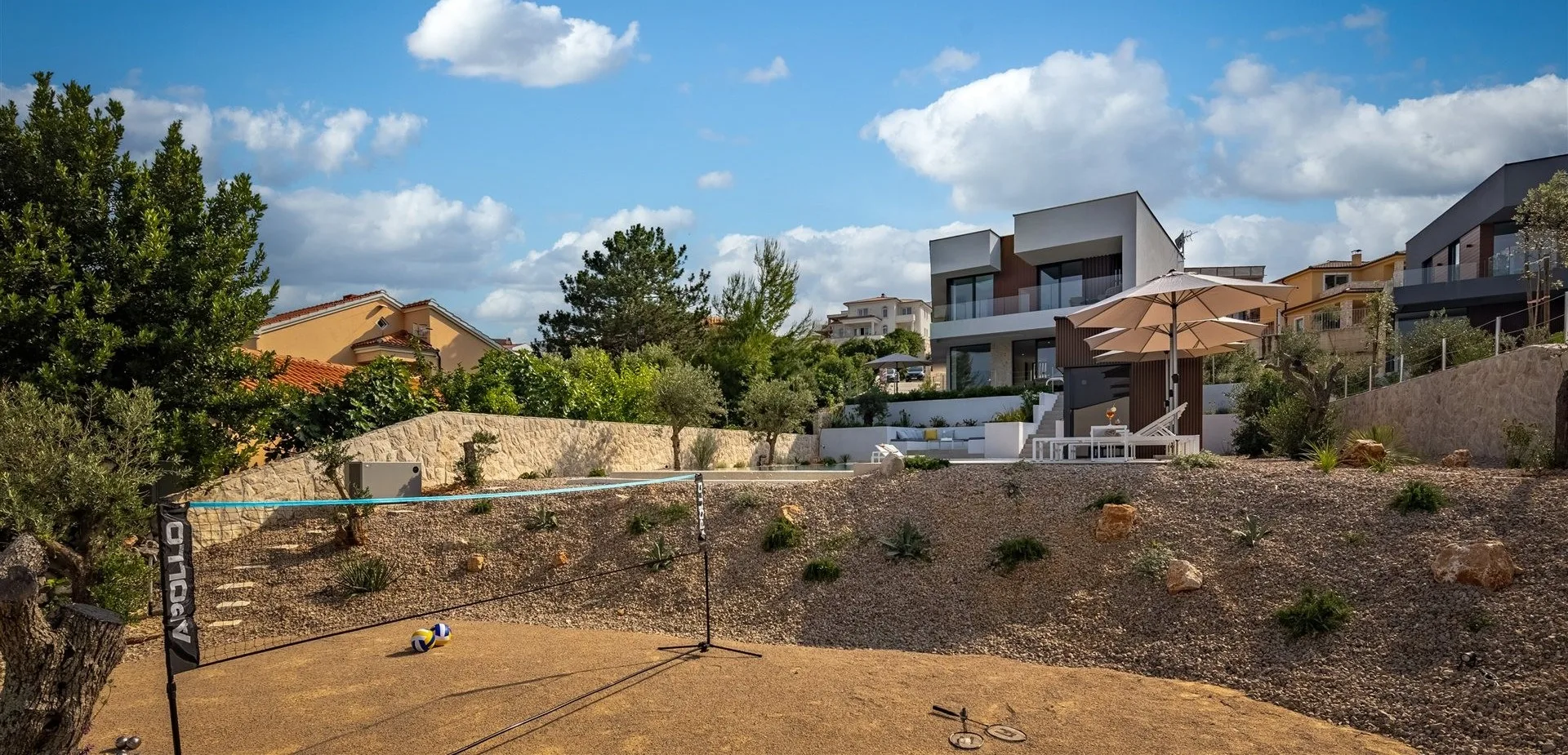 Villa Manatis sand court — volleyball, bocce, barefoot evenings