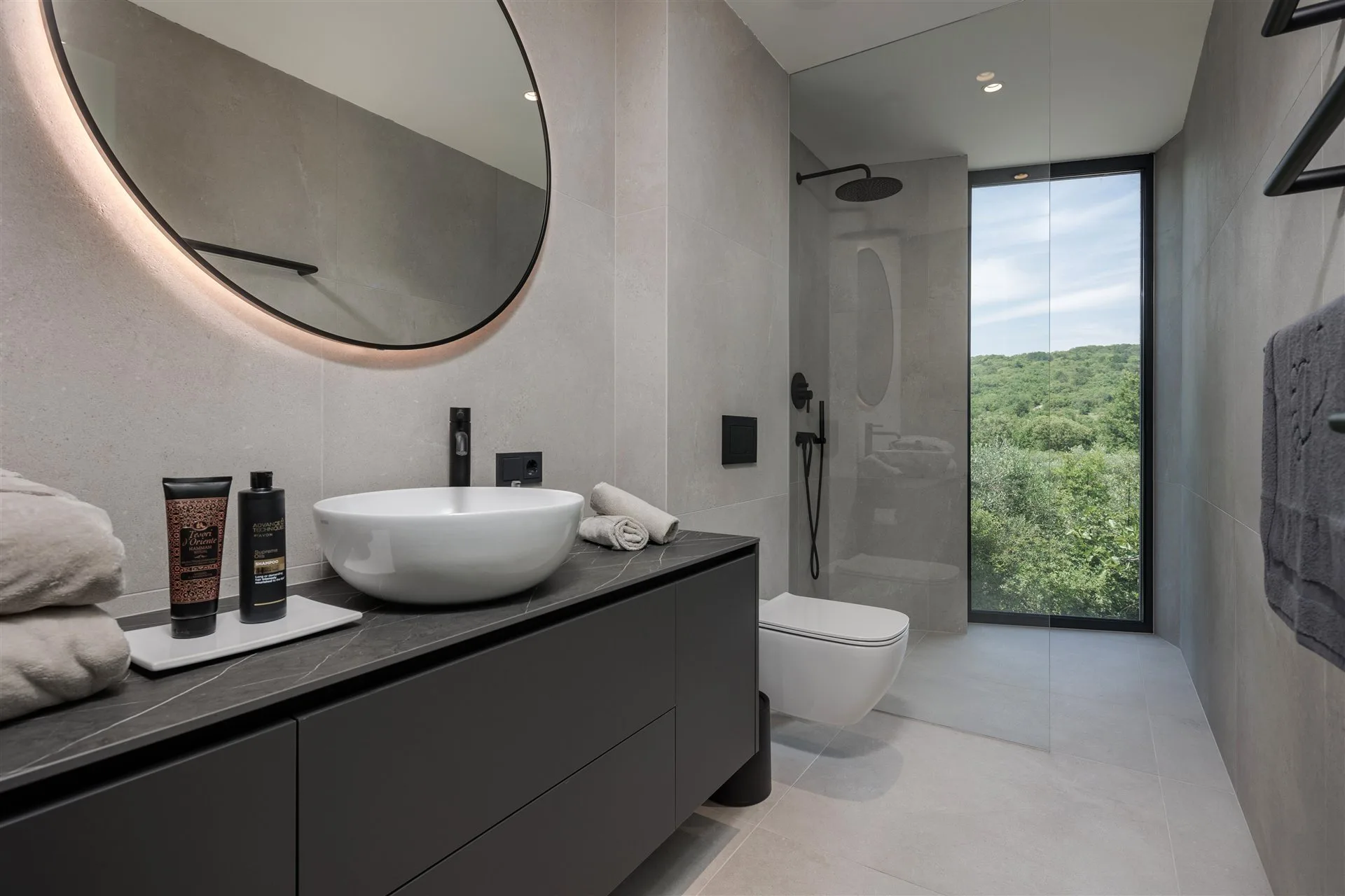 Villa Moana luxury bathroom with curved basin and garden view