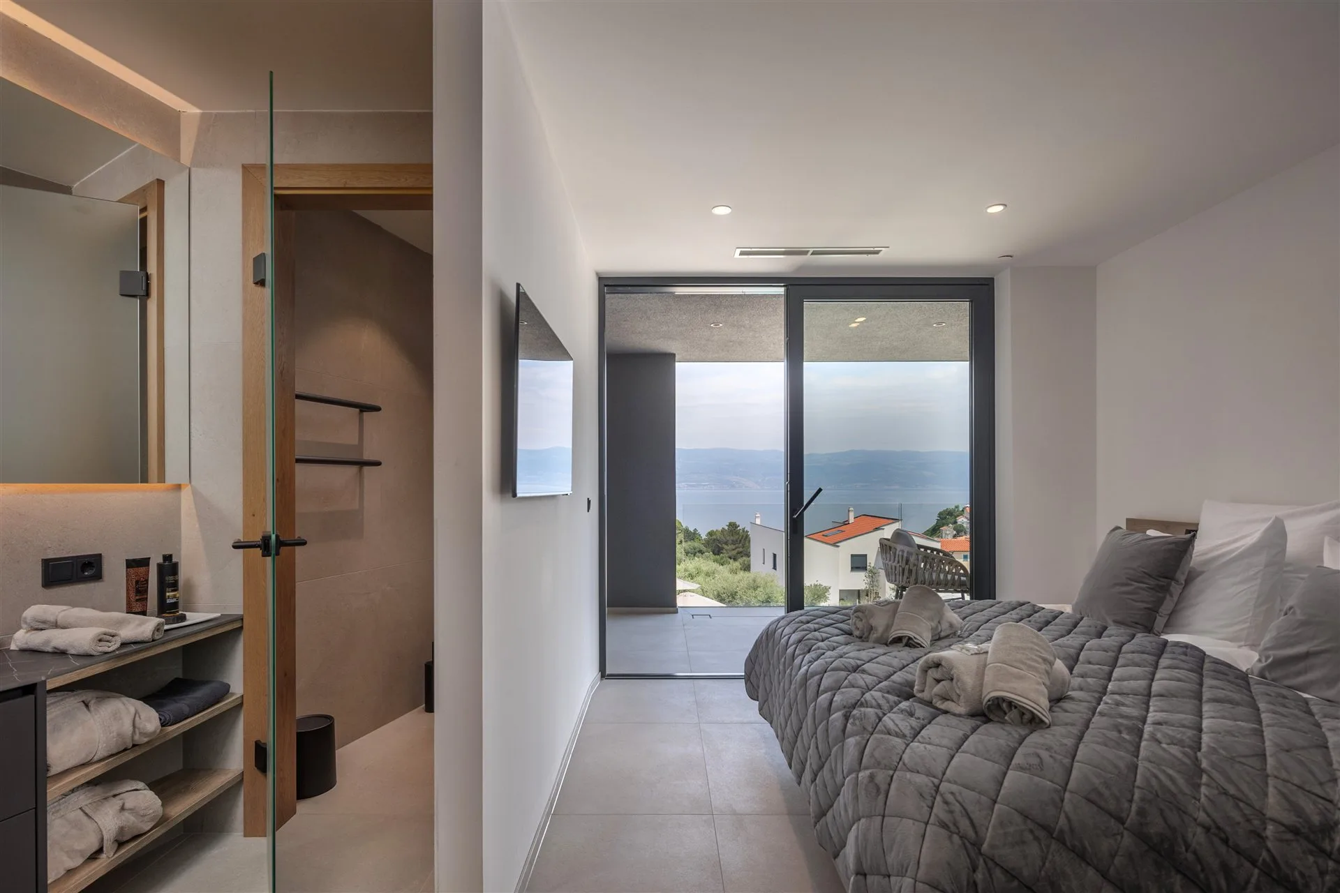 Villa Moana bedroom with Adriatic sea view — en-suite glass wall and terrace access