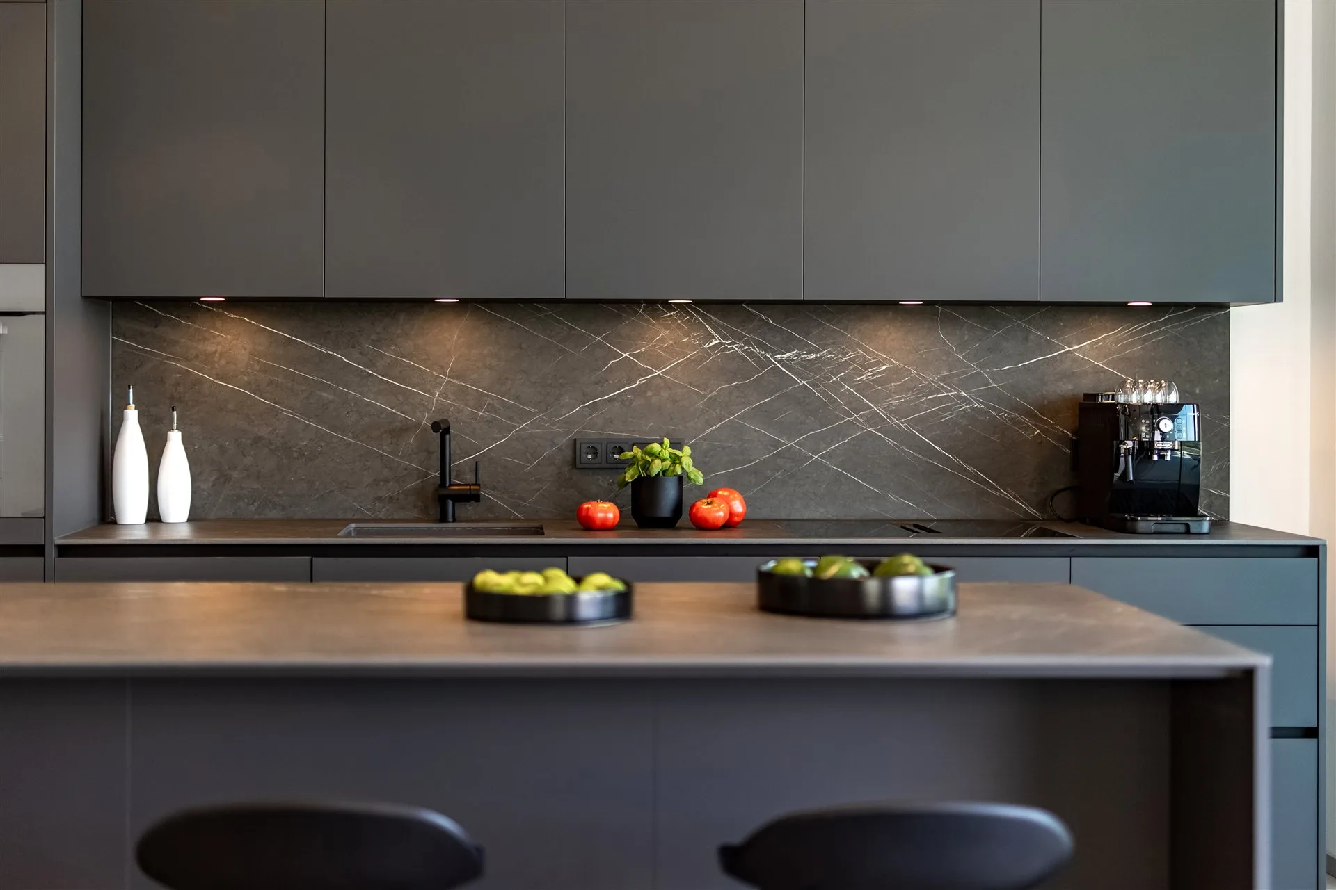 Villa Moana fully equipped kitchen with dark cabinetry and stone island