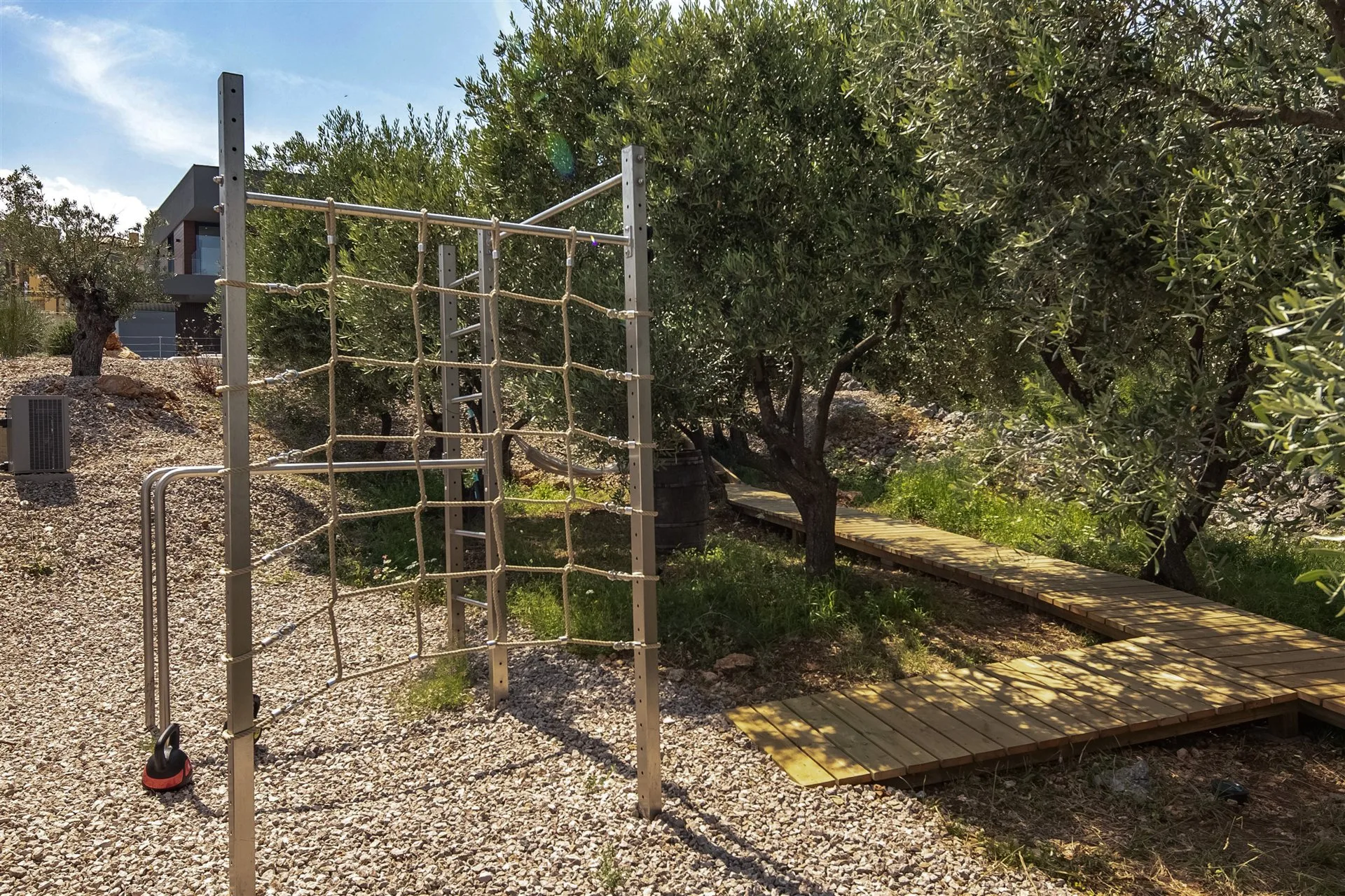 Villa Moana outdoor gym — pull-up and climbing frame among centuries-old olive trees