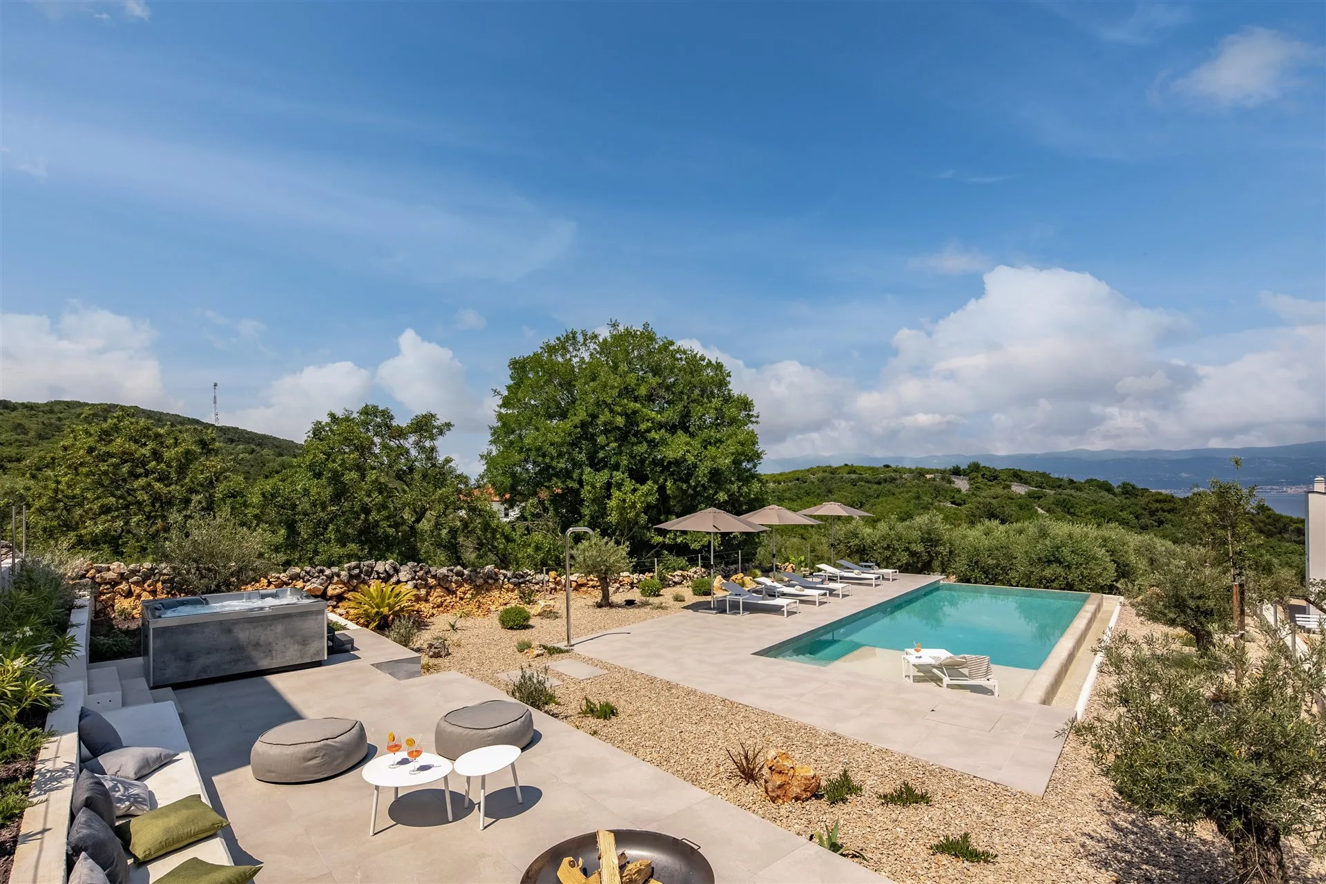 Villa Moana covered terrace with pool, lounge seating and open Adriatic sky