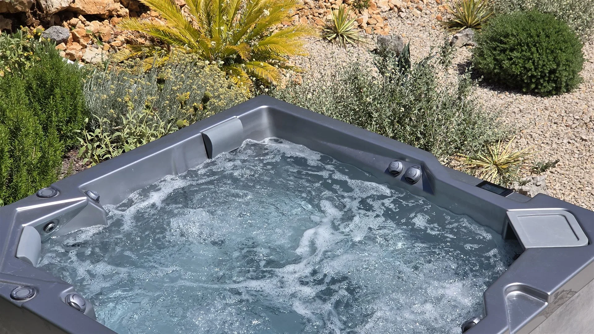 Villa Moana whirlpool with jets running, surrounded by Mediterranean garden